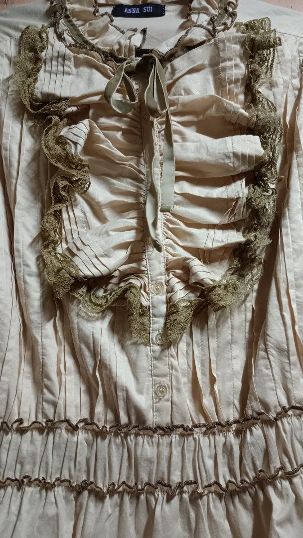 Anna Sui Victorian Vintage Ruffled Blouse (Category: Blouses) located in Quezon City. Submitted by prelovedbyscarlett (Listing ID 1469188038, Image 2). Description: Cream with olive green lace ruffles Velvet tie-neck bow, pleated front panel, smocked waist peplum hem Flat measurements: Shoulders - 14 in Chest - 17.5 in Waist - 15 in (stretchable) Cuffs - 4.5 in Vintage Style | Coquette |Fairy Grunge | Romantic.