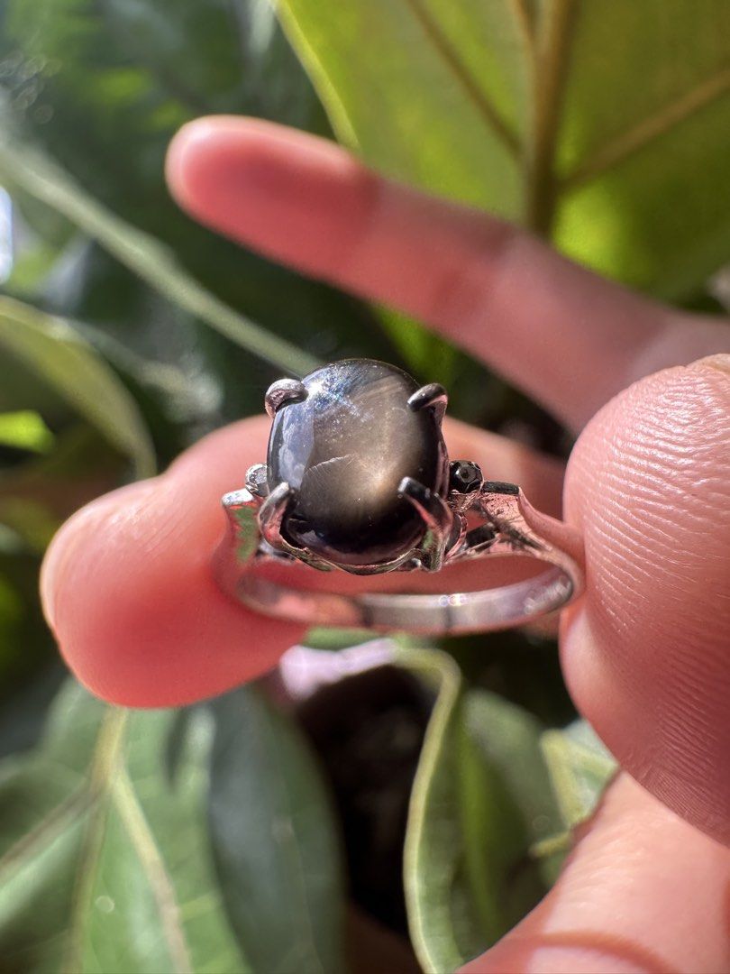 Antique Black Star Sapphire Ring Size 6 (Category: Rings) located in Mandaluyong City. Submitted by chyckenwings (Listing ID 1469181064, Image 2). Description: Preloved antique-style, high cathedral setting ring featuring an oval cabochon-cut dark stone. Stone is consistent with natural black star sapphire or a star diopside with rocky stone formation at the back. Ring is set in a silver-toned metal band with markings SING'S. Band seemed to be re