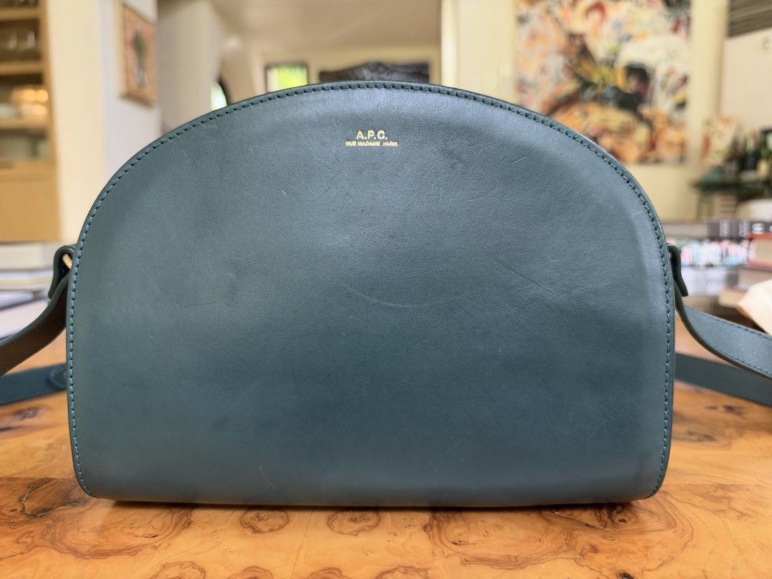 A.P.C. Half Moon Bag Dark Green (Category: Cross-body Bags) located in Muntinlupa City. Submitted by katoshops (Listing ID 1469200917, Image 3). Description: A.P.C. Demi-Lune Half-Moon Bag Current Market Price: 495.00 USD Selling Price: ₱5,500.00 Condition: Good (8/10) Reason for Selling: Don’t get to use this bag anymore. Additional Details: Color: Dark Green Worn: Used occasionally Flaws: - Light surface scratches and scuff marks: Visible on th