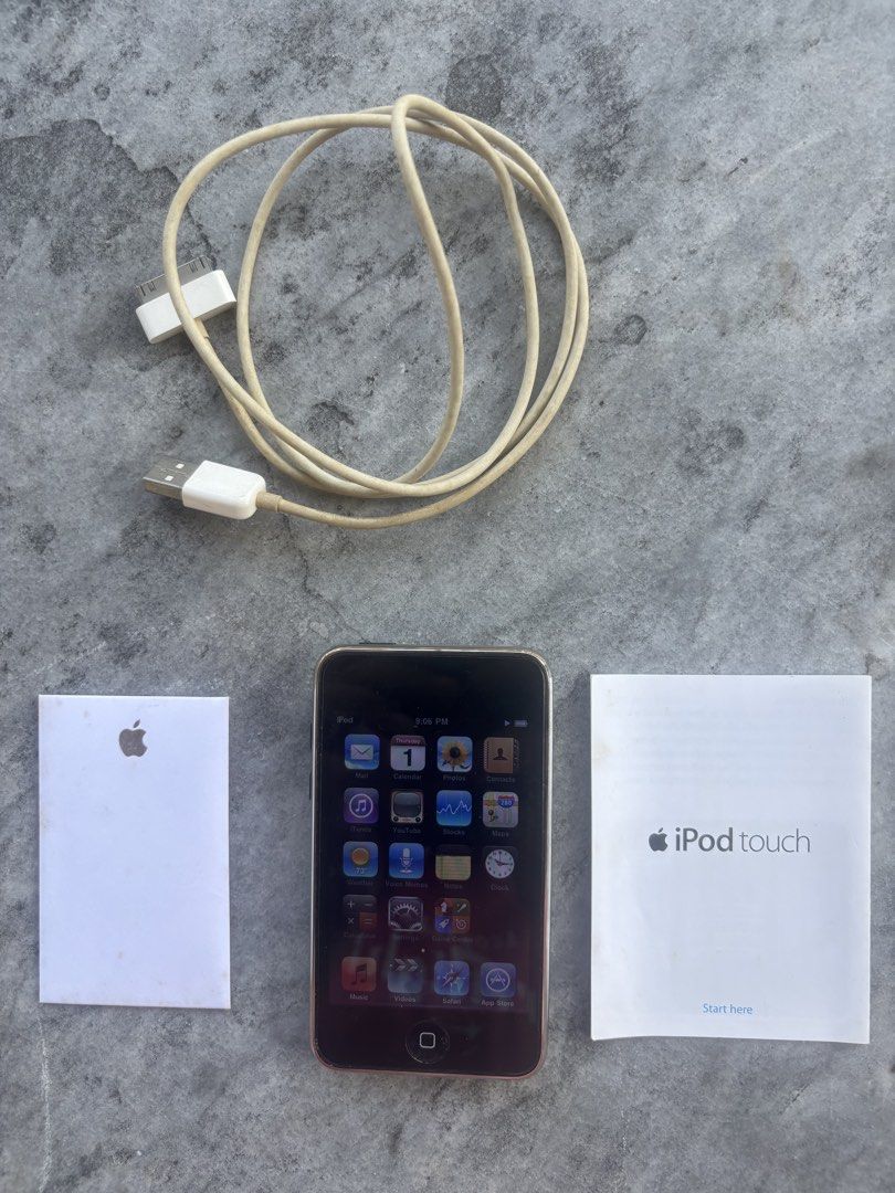 Apple iPod touch with 30-pin Cable and Manuals (Category: Portable Music Players) located in Iloilo. Submitted by TheKinfolkGarage (Listing ID 1469169313, Image 1). Description: - Vintage Apple iPod touch running early iOS - Features classic skeuomorphic icons (Mail, Calendar, Photos, YouTube) - Includes original 30-pin USB charging cable (slight yellowing from age) - Original documentation booklet and Apple sticker included - Screen lights up an