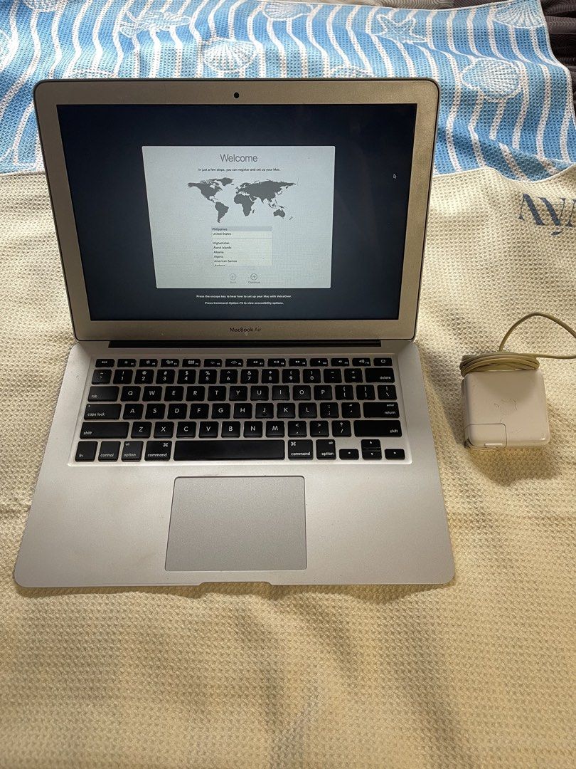 Apple MacBook Air with Power Adapter (Category: Laptops & Notebooks) located in Paranaque City. Submitted by shop.momo (Listing ID 1469241977, Image 2). Description: - Model: Apple MacBook Air (Silver) - Condition: Decent shape, ready for new user setup - Inclusions: Original power adapter and cable (power brick has minor yellowing from use) - Keyboard & Trackpad: Standard QWERTY layout - Extras: Cute flower sticker on the outer aluminum lid - Ri