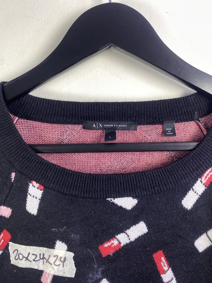 Armani Exchange Lipstick Print Knit Sweater (Category: Longsleeves) located in Manila. Submitted by declutterpromax (Listing ID 1469201974, Image 3). Description: - Brand: Armani Exchange - Style: Black knit sweater with allover red & white lipstick pattern - Size: Large - Details: Long sleeves, ribbed collar, cuffs, and hem - Origin: Made in China - Authenticity: Includes care tag and verifiable Certilogo QR code - Condition: Excellent.