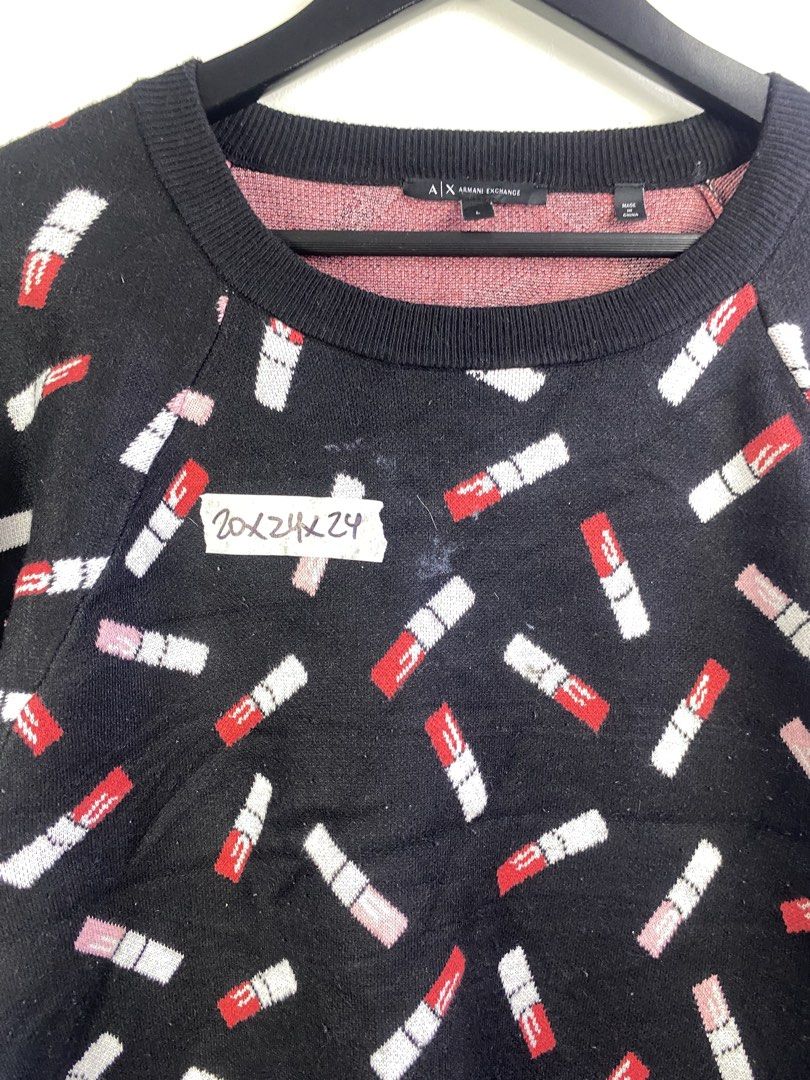 Armani Exchange Lipstick Print Knit Sweater (Category: Longsleeves) located in Manila. Submitted by declutterpromax (Listing ID 1469201974, Image 2). Description: - Brand: Armani Exchange - Style: Black knit sweater with allover red & white lipstick pattern - Size: Large - Details: Long sleeves, ribbed collar, cuffs, and hem - Origin: Made in China - Authenticity: Includes care tag and verifiable Certilogo QR code - Condition: Excellent.