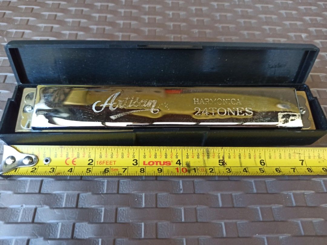 Artisan Harmonica 24 Tones with Case (Category: Musical Instruments) located in Caloocan City. Submitted by rtarellano (Listing ID 1469289200, Image 2). Description: - Type: Artisan 24-tones tremolo harmonica - Design: Shiny silver-tone cover plates with engraved script logo and standard double-sided hole layout - Size: Approximately 7 inches long - Condition: Clean metal finish, excellent and ready to play - Inclusions: Original black hard plast