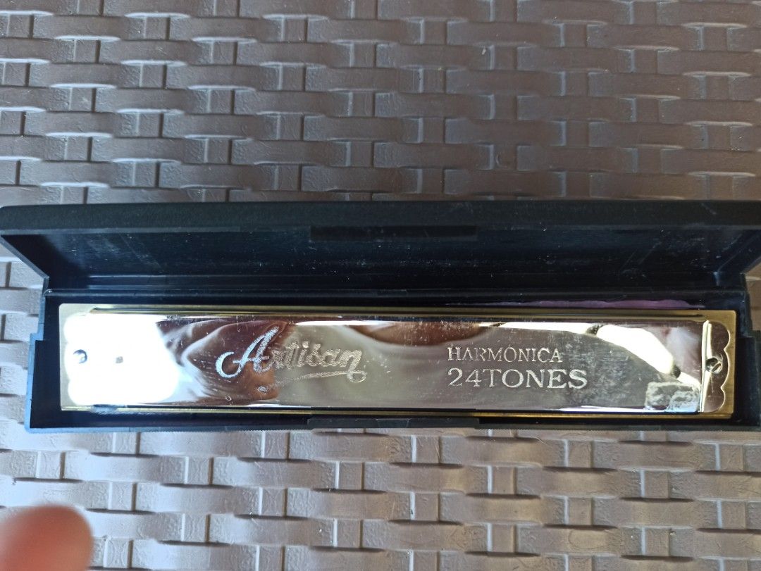 Artisan Harmonica 24 Tones with Case (Category: Musical Instruments) located in Caloocan City. Submitted by rtarellano (Listing ID 1469289200, Image 3). Description: - Type: Artisan 24-tones tremolo harmonica - Design: Shiny silver-tone cover plates with engraved script logo and standard double-sided hole layout - Size: Approximately 7 inches long - Condition: Clean metal finish, excellent and ready to play - Inclusions: Original black hard plast