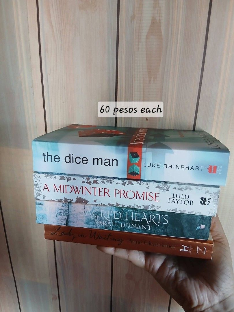 Assorted Fiction Paperbacks - The Dice Man & More (Category: Storybooks) located in Tarlac. Submitted by therecluse.bibliophileph (Listing ID 1469280343, Image 1). Description: - Titles: The Dice Man by Luke Rhinehart, A Midwinter Promise by Lulu Taylor, Sacred Hearts by Sarah Dunant, Lady in Waiting by Anne Glenconner - Price: 60 pesos each - Format: Standard paperback size - Condition: Readable condition overall - Option to buy individually or 