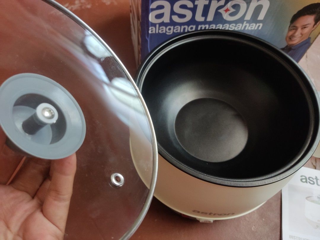 Astron Masterpot 180 Multi-Purpose Electric Cooker (Category: Cookers) located in Cordon. Submitted by joymantis (Listing ID 1469175844, Image 3). Description: - Brand: Astron Masterpot 180 Multi-Purpose Electric Cooker - Color: Cream and grey body with black non-stick inner pot - Capacity & Power: 1.8 Liters, 600 Watts, 230V - Features: Ideal for quick meals, boiling, frying, and perfect for dorms or small spaces - Inclusions: Clear glass lid, p