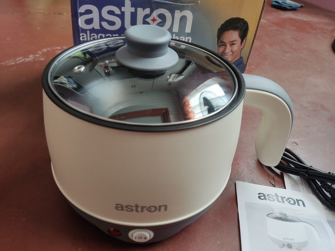 Astron Masterpot 180 Multi-Purpose Electric Cooker (Category: Cookers) located in Cordon. Submitted by joymantis (Listing ID 1469175844, Image 1). Description: - Brand: Astron Masterpot 180 Multi-Purpose Electric Cooker - Color: Cream and grey body with black non-stick inner pot - Capacity & Power: 1.8 Liters, 600 Watts, 230V - Features: Ideal for quick meals, boiling, frying, and perfect for dorms or small spaces - Inclusions: Clear glass lid, p