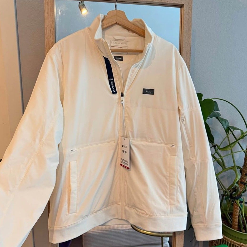 Authentic and New FIGS Team USA Jacket (Category: Coats, Jackets and Outerwear) located in San Juan. Submitted by docpratty (Listing ID 1469214483, Image 1). Description: New with tags Team USA jacket AUTHENTIC Color: off white Size: men’s large Originally 158 dollars.