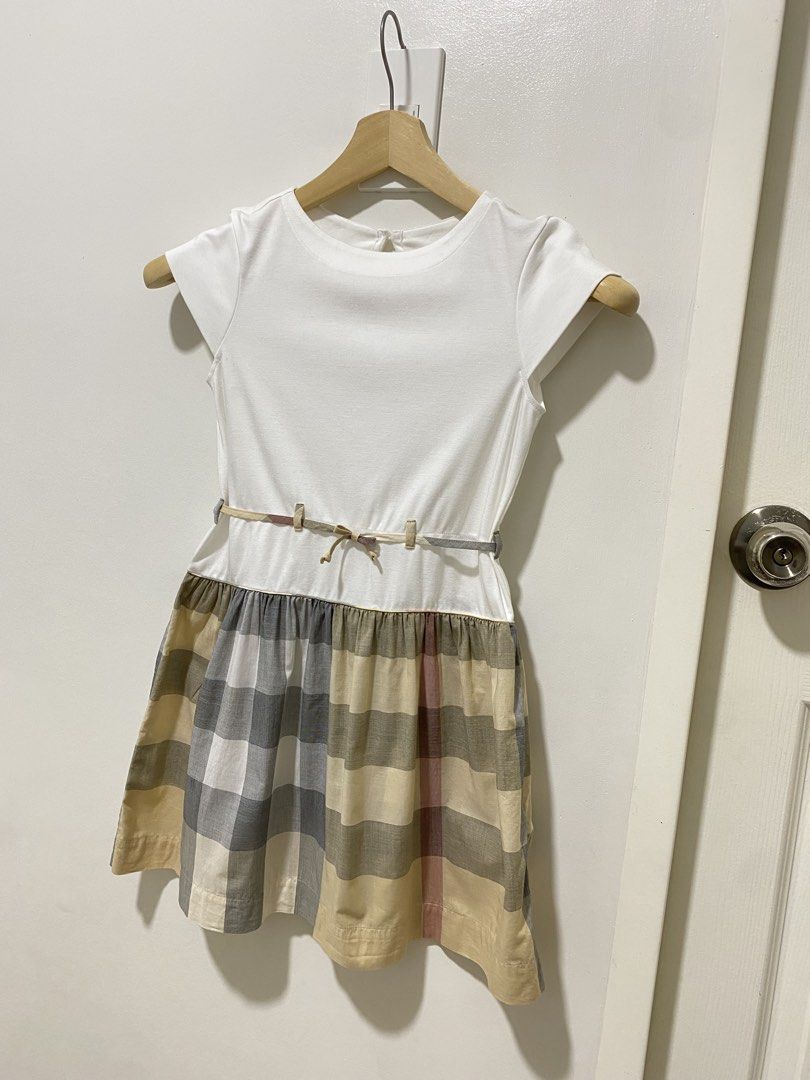 Authentic Burberry Dress 10 y/o (Category: Babies & Kids Fashion) located in Las Pinas. Submitted by sherylandmargaux (Listing ID 1469222338, Image 2). Description: Classic white bodice dress with a soft plaid skirt. Features a subtle belt detail for a polished look. Comfortable short sleeves and a full skirt designed for everyday wear. The white and gray plaid colors blend for versatile styling..