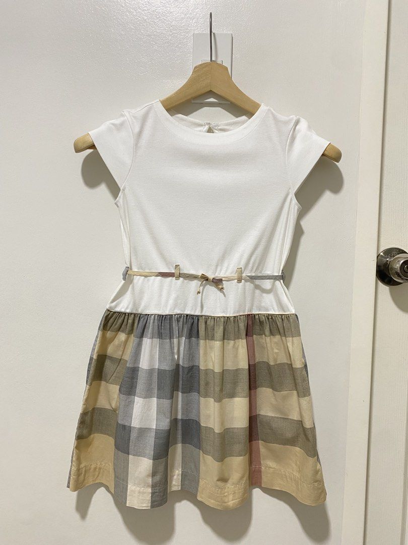 Authentic Burberry Dress 10 y/o (Category: Babies & Kids Fashion) located in Las Pinas. Submitted by sherylandmargaux (Listing ID 1469222338, Image 1). Description: Classic white bodice dress with a soft plaid skirt. Features a subtle belt detail for a polished look. Comfortable short sleeves and a full skirt designed for everyday wear. The white and gray plaid colors blend for versatile styling..