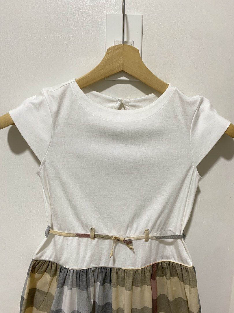 Authentic Burberry Dress 10 y/o (Category: Babies & Kids Fashion) located in Las Pinas. Submitted by sherylandmargaux (Listing ID 1469222338, Image 3). Description: Classic white bodice dress with a soft plaid skirt. Features a subtle belt detail for a polished look. Comfortable short sleeves and a full skirt designed for everyday wear. The white and gray plaid colors blend for versatile styling..