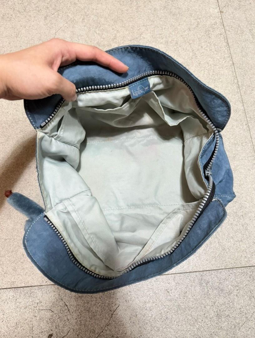 Authentic Kipling Trim ZT Large Toiletry Bag (Category: Shoulder Bags) located in Malabon City. Submitted by angelamaclan (Listing ID 1469244580, Image 3). Description: - Brand: Kipling - Inclusions: Iconic furry monkey keychain - Exterior: Front zipped pocket with round Kipling logo patch and secure top zip closure - Interior: Roomy compartment with light-coloured lining (note: has some faint stains at the bottom) - Condition: Pre-loved, functio