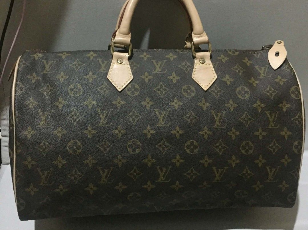 Authentic Louis Vuitton Monogram Canvas Speedy Handbag (Category: Luxury Bags & Wallets) located in Manila. Submitted by preloved119 (Listing ID 1469273579, Image 1). Description: - Authentic Louis Vuitton Monogram Speedy handbag in classic brown canvas - Dual rolled leather top handles and brass hardware - Secure zip top closure featuring an Eclair zipper pull - Brown textile interior lining with a spacious open compartment - Natural cowhide lea