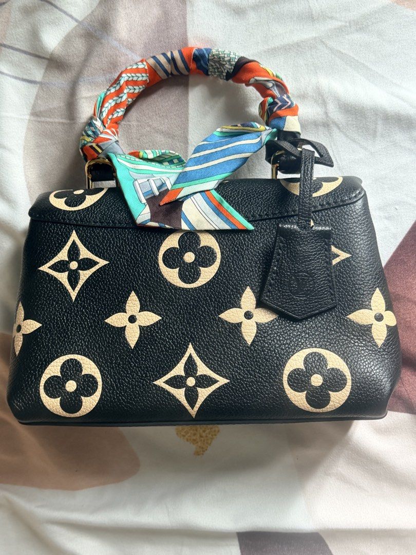 Authentic LV Madeleine (Category: Announcements) located in Bacolod City. Submitted by blackwidow28 (Listing ID 1469221277, Image 2). Description: Authentic Louis Vuitton Madeleine 🖤✨ Pre-loved condition with minor tarnishing on the hardware and hairline scratches on the lock from normal use. Aside from these, no other flaws noted. Please see the photos for the actual condition. ❤️ Microchipped Priced accordingly. Serious buyers only..