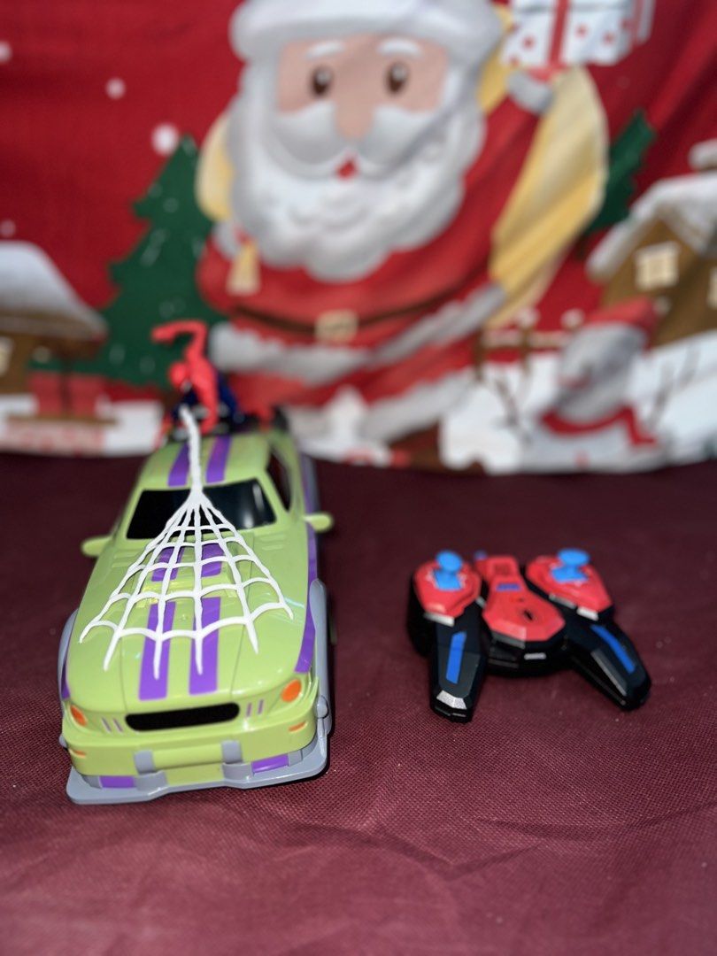 Authentic Marvel Spider-Man RC Car with Controller (Category: Remote Control Toys) located in Manila. Submitted by aiguuurl165091 (Listing ID 1469258997, Image 2). Description: - Official Marvel Spider-Man remote control toy car - Cool green and purple design with attached Spider-Man figure and white web hood detail - Includes matching red, black, and blue wireless controller with dual thumb sticks - Officially branded on the rear spoiler - Fully