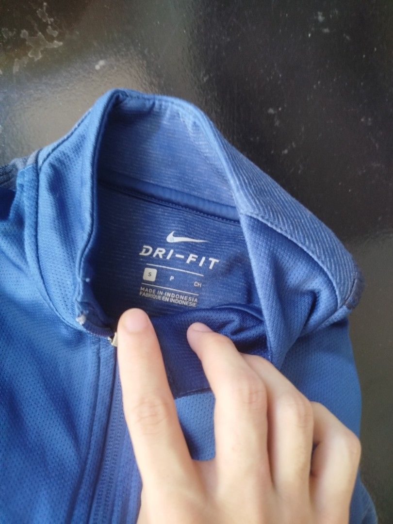 Authentic Nike Dri-FIT Blue Track Jacket (Category: Coats, Jackets and Outerwear) located in Rizal. Submitted by silenttiger_43bf91 (Listing ID 1469194843, Image 2). Description: - Authentic blue Nike training jacket - Dri-FIT moisture-wicking material keeps you dry during workouts - Full zip front with high collar and ribbed cuffs - Stylish darker blue stripes down shoulders and sleeves - Embroidered Nike swoosh on right chest - Perfect for gym 