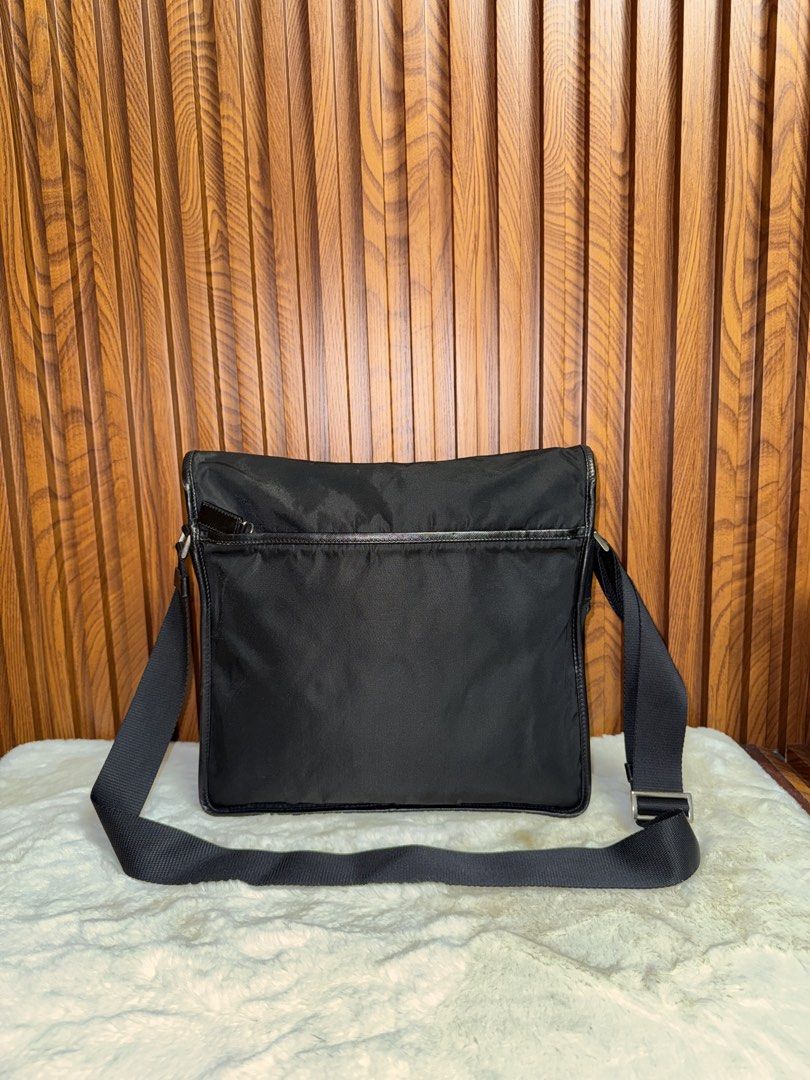 Authentic Prada Black Nylon Messenger Bag with Buckle (Category: Everything Else Others) located in Subic. Submitted by luxshoppe88 (Listing ID 1469279233, Image 3). Description: - Brand: Prada - Material: Classic black nylon - Closure: Front flap with branded metal buckle - Strap: Adjustable black shoulder strap - Pockets: Exterior back zip pocket and interior zip pocket - Interior: Signature Prada jacquard lining with metal logo plaque - Condit