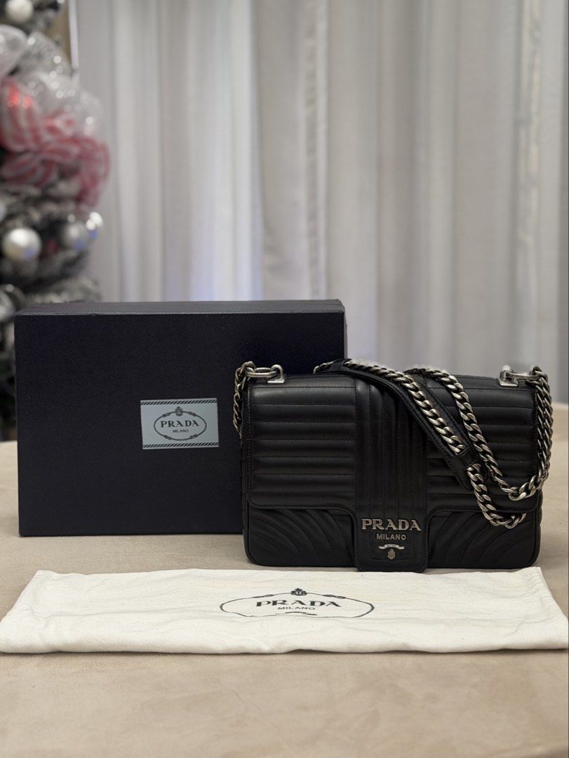 Authentic Prada Diagramme Chain Flap Bag in Medium size (Category: Luxury Bags & Wallets) located in Manila. Submitted by maria_2326 (Listing ID 1458394589, Image 1). Description: Prada Diagramme Chain Flap Medium Size Guarantee Authentic Inclusions: Box and dust bag No to lowballing! Location: Manila/QC.
