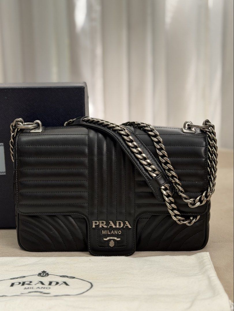Authentic Prada Diagramme Chain Flap Bag in Medium size (Category: Luxury Bags & Wallets) located in Manila. Submitted by maria_2326 (Listing ID 1458394589, Image 2). Description: Prada Diagramme Chain Flap Medium Size Guarantee Authentic Inclusions: Box and dust bag No to lowballing! Location: Manila/QC.