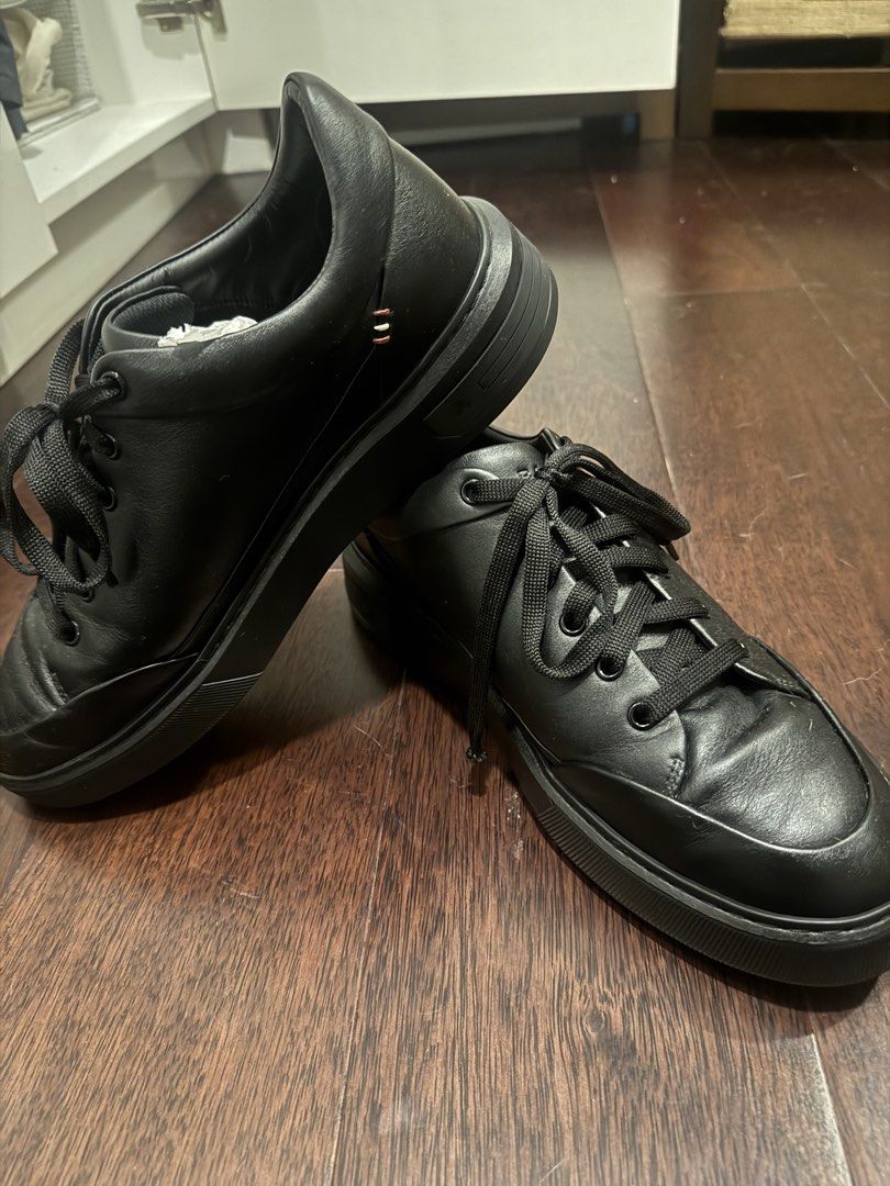 Bally Melvin Black Leather Sneakers (Category: Sneakers) located in Pateros City. Submitted by dependingonvibe (Listing ID 1469254759, Image 1). Description: - Brand: Bally Melvin - Color: Classic black leather - Style: Minimalist design with tonal black laces and subtle heel stitching - Soles: Chunky textured rubber with minimal wear - Condition: Clean overall condition with normal leather creasing from wear - Details: Interior stamped with Ball