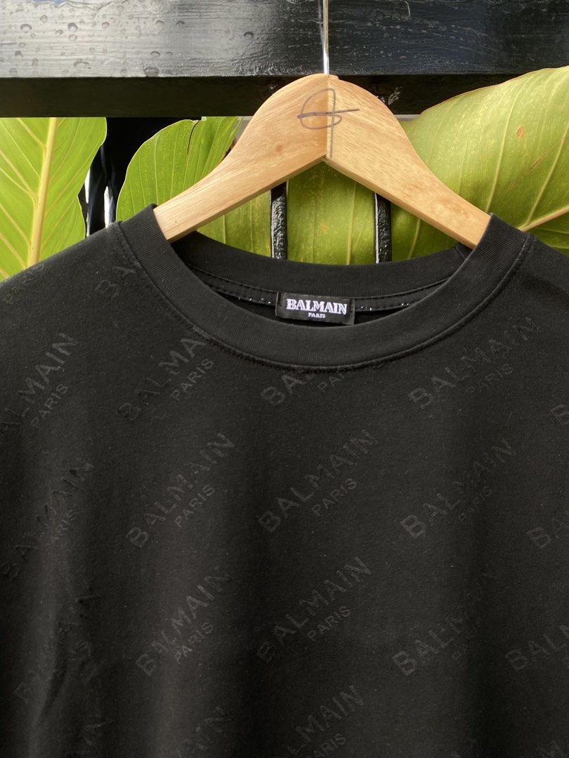 Balmain Paris Black Monogram T-Shirt (Category: Luxury Apparel) located in Roxas City. Submitted by dua-garments23 (Listing ID 1469206840, Image 2). Description: - Brand: Balmain Paris - Item: Black short sleeve t-shirt with all-over debossed logo pattern - Material: 100% cotton (main), viscose and silk blend (lining) - Neckline: Classic crew neck - Origin: Made in Portugal - Style Code: 18S 7369 342 - Condition: Great piece for casual wear, very
