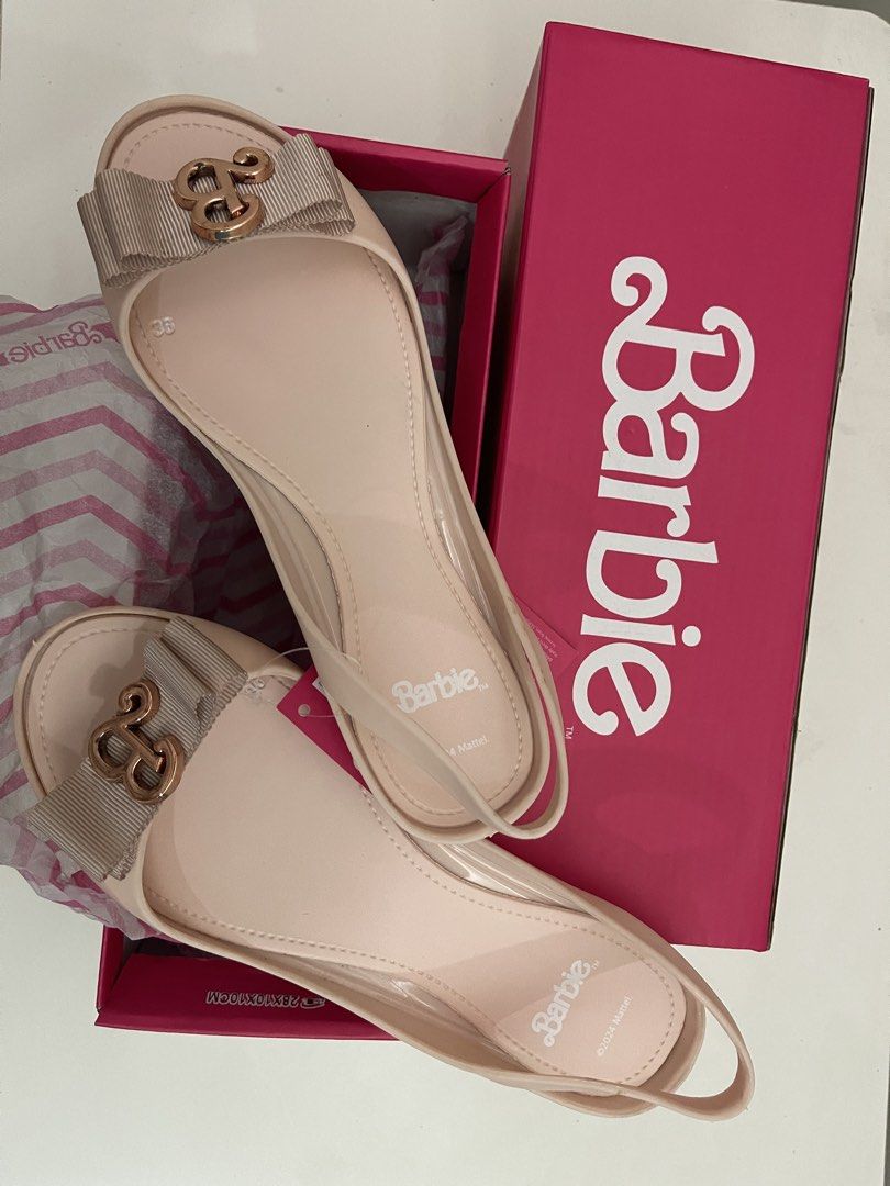 Barbie Nage Slingback Flats Nude Size 36 (Category: Flats & Sandals) located in Quezon City. Submitted by bravehorse_f1f6d5 (Listing ID 1469287093, Image 2). Description: - Brand: Barbie (Nage model) - Style: Slingback flats with open-toe design - Color: Versatile nude - Size: EU 36 - Details: Cute ribbon bow with gold 'B' monogram - Condition: Brand new - Inclusions: Original pink Barbie box and packaging tissue - Perfect for gifting or adding a