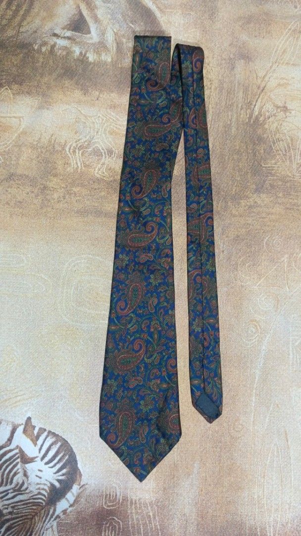 Barton Moda Italian Silk Paisley Tie (Category: Ties) located in Cavite. Submitted by navias (Listing ID 1469345824, Image 3). Description: - Brand: Barton Moda - Material: 100% Pure Silk (Made in Italy) - Design: Classic blue base with rich red and green paisley pattern - Construction: Hand-made, traditional width and length - Condition: Clean, nicely preserved - Best for: Office wear, business meetings, or formal events.
