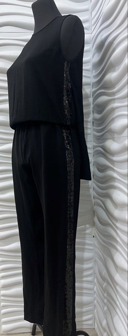 BCBGMAXAZRIA Black Sequin Trim Jumpsuit (Category: Jumpsuits) located in Las Pinas. Submitted by sabsking (Listing ID 1469170113, Image 3). Description: - Brand: BCBGMAXAZRIA - Color: Black - size can fit small to med - Design: Sleeveless with open back detail - Accent: Eye-catching sparkly sequin trim down both sides - Fit: Straight leg pants with a waist strap for a flattering silhouette - Closure: Button closure at the back neck ₱1000 plus sf.