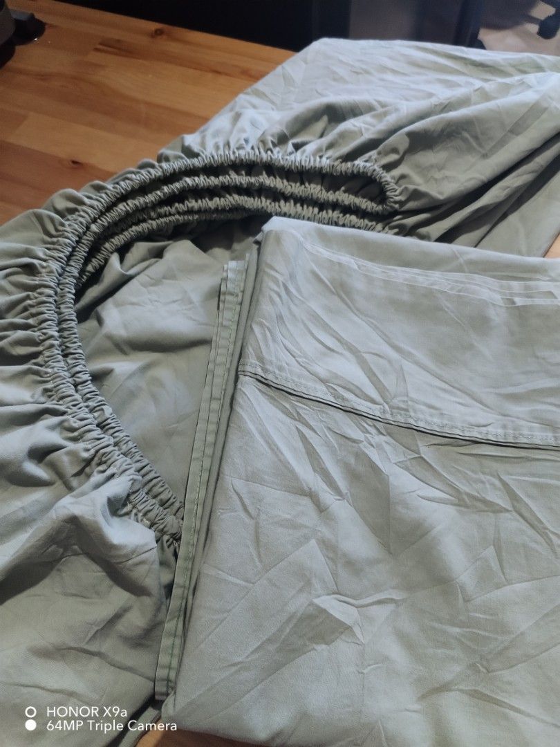 Bedsheet & Flatsheet ( Queen size) (Category: Bedding & Towels) located in Muntinlupa City. Submitted by arciagamaryann68 (Listing ID 1469218358, Image 2). Description: - Item: Queen size bedsheet & flatsheet set - Color: Sage green - Features: Fully elasticized fitted sheet for a secure fit - Condition: Good, well-kept - Ideal for updating your bedroom decor with a cozy and relaxing vibe.