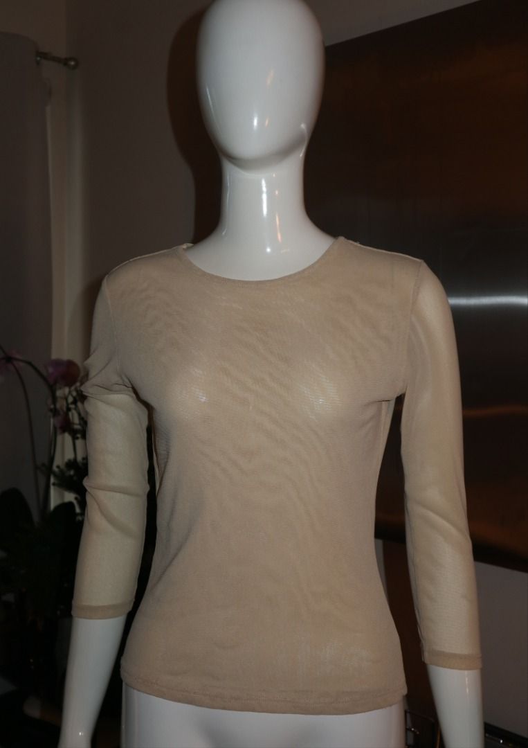Beige Sheer Three-Quarter Sleeve Top (Category: Blouses) located in Paranaque City. Submitted by skulkch (Listing ID 1469362413, Image 2). Description: - Color: Nude beige - Material: Lightweight, stretchy sheer mesh - Design: Round neckline, 3/4 length sleeves - Versatility: Perfect as a layering piece or worn on its own - Condition: Excellent, clean collar and hem with no stains or rips.