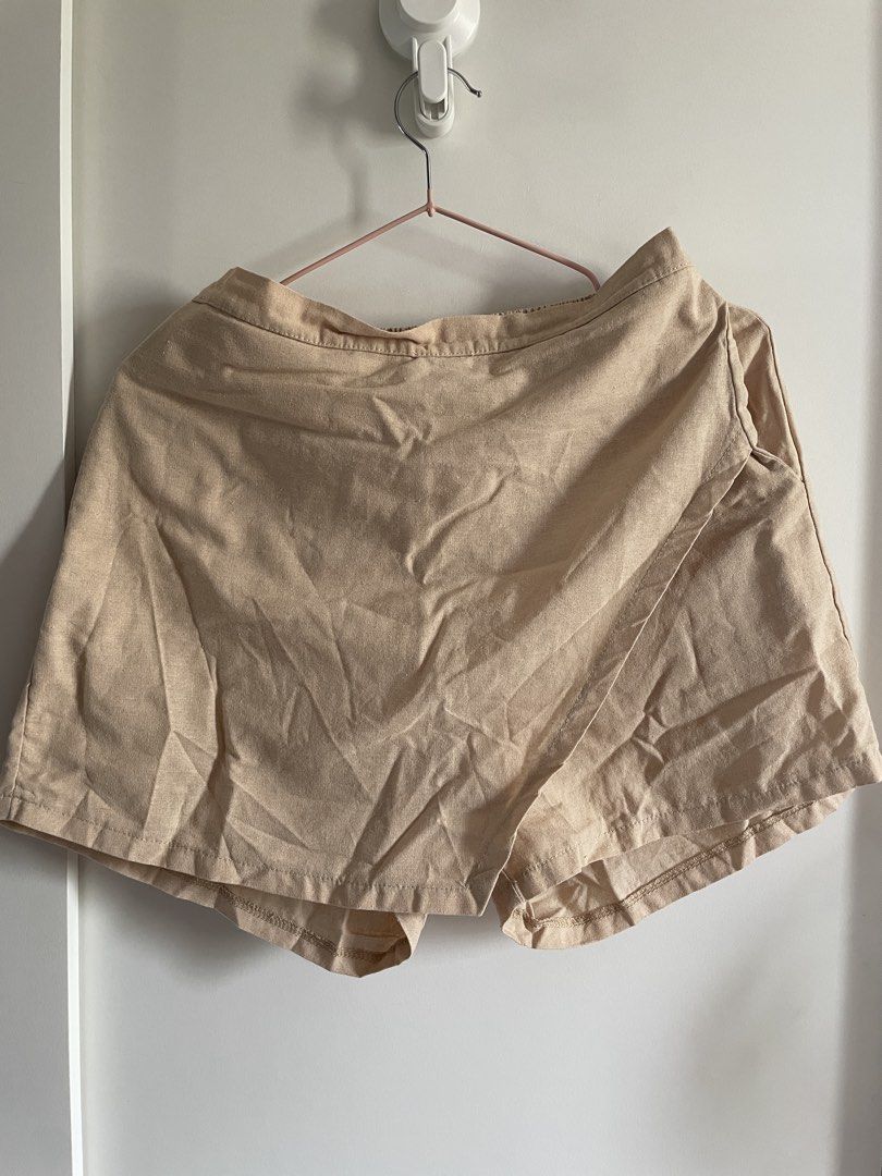 Beige wrap skort elastic waist (Category: Shorts) located in Agdangan. Submitted by happyphoenix.d92869 (Listing ID 1469211425, Image 1). Description: - Color: Versatile beige - Style: Casual skort with an overlapping front panel for a skirt look - Comfort: Built-in shorts for easy and confident movement - Fit: Elastic waistband at the back for a comfortable fit - Material: Lightweight fabric ideal for daily wear - Pairing: Easily matches with ba