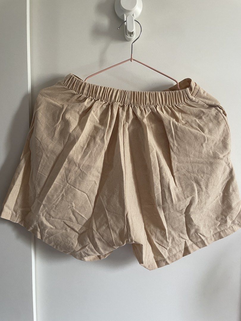 Beige wrap skort elastic waist (Category: Shorts) located in Agdangan. Submitted by happyphoenix.d92869 (Listing ID 1469211425, Image 2). Description: - Color: Versatile beige - Style: Casual skort with an overlapping front panel for a skirt look - Comfort: Built-in shorts for easy and confident movement - Fit: Elastic waistband at the back for a comfortable fit - Material: Lightweight fabric ideal for daily wear - Pairing: Easily matches with ba