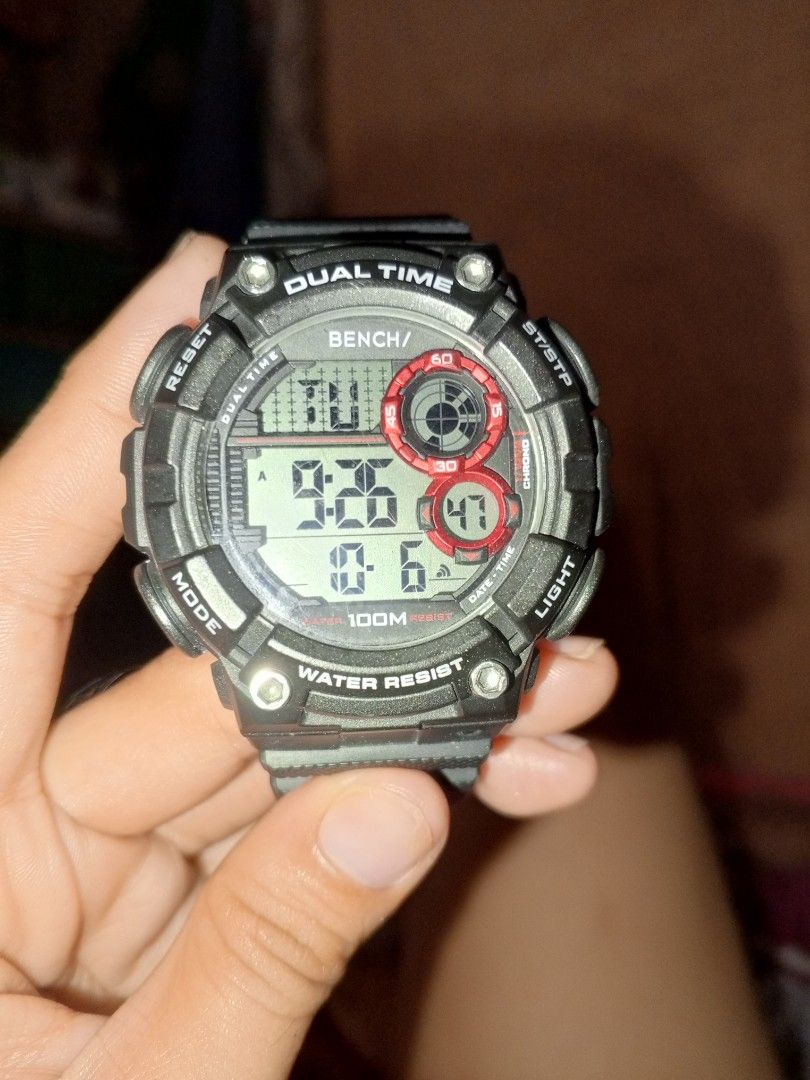 Bench BH2666Y Dual Time Digital Watch (Category: Men's Watches) located in Manila. Submitted by melantha12 (Listing ID 1469260342, Image 2). Description: - Brand: Bench - Model: BH2666Y - Display: Dual time digital display - Water Resistance: 100M (Great for swimming and daily wear) - Design: Dark grey resin case and strap with striking red dial accents - Backlight: Working bright green backlight for low-light visibility - Case Back: Durable stai