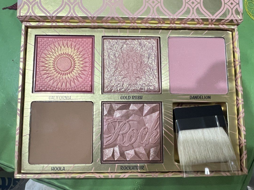Benefit Cosmetics Blush Bar Palette (Category: Makeup) located in Quezon City. Submitted by mmjjc (Listing ID 1469168882, Image 2). Description: • GALifornia: Sunny golden-pink / bright coral-pink blush with a luminous shimmer. • Gold Rush: Warm golden-nectar / light golden-peach blush with a signature citrus-vanilla-sandalwood scent. • Dandelion: Sheer, soft baby-pink brightening and finishing powder. • Hoola: Classic matte pale-brown bronzer. •