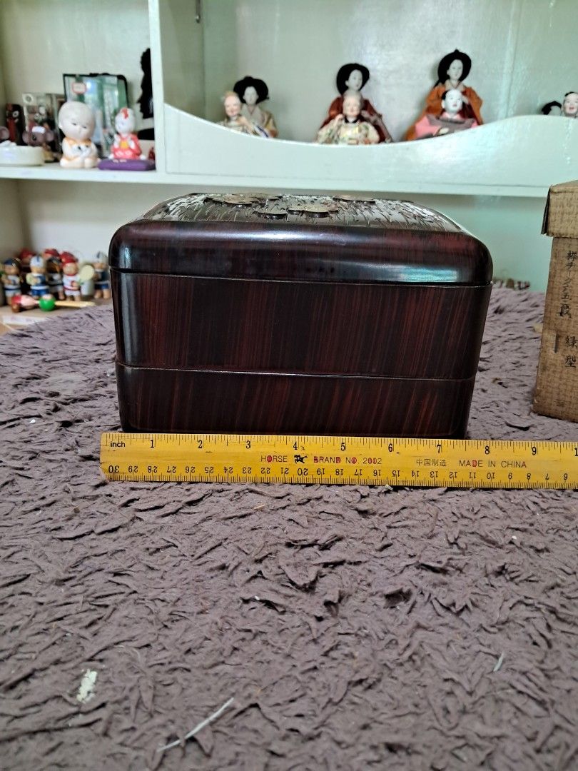 Bento box (Category: Other Kitchenware & Tableware) located in Cavite. Submitted by secretjapansurplus (Listing ID 1469217066, Image 2). Description: • Item Type: 2-Tier Japanese Bento Box) • Material: Durable ABS Resin / Molded Polymer with a high-gloss protective finish (Bento box material) • Condition: Vintage. Beautifully preserved with a high-shine finish and minor, natural signs of age on the outer surfaces. • Lid Design: Carved linear text