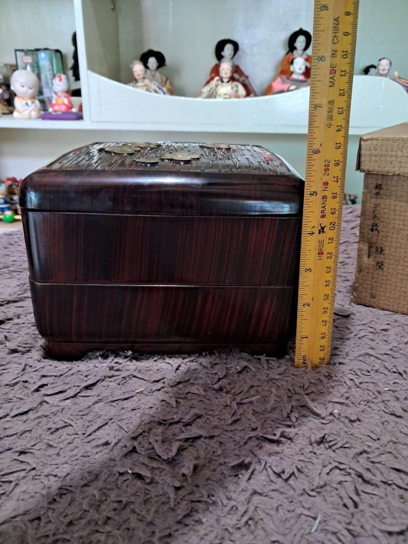 Bento box (Category: Other Kitchenware & Tableware) located in Cavite. Submitted by secretjapansurplus (Listing ID 1469217066, Image 3). Description: • Item Type: 2-Tier Japanese Bento Box) • Material: Durable ABS Resin / Molded Polymer with a high-gloss protective finish (Bento box material) • Condition: Vintage. Beautifully preserved with a high-shine finish and minor, natural signs of age on the outer surfaces. • Lid Design: Carved linear text