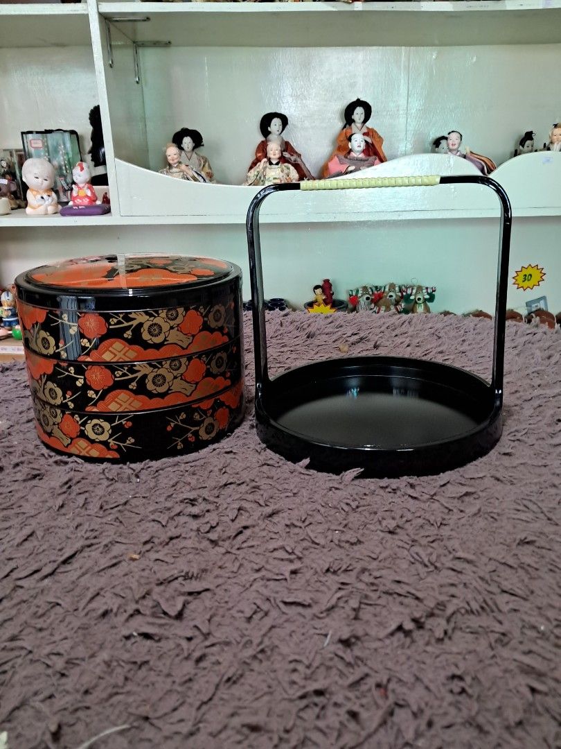 Bento box 3 layer (Category: Storage Boxes & Baskets) located in Cavite. Submitted by secretjapansurplus (Listing ID 1469214742, Image 3). Description: condition! Complete with its original storage box. A beautiful 3-tier round stacking food container featuring a glossy black base decorated with vibrant red and gold plum blossom (ume) motifs. • Condition: Pristine, never been used (old stock) • Dimensions: Approximately 7.5 to 8 inches in diamete
