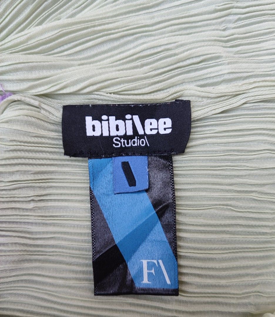bibilee studio pleated green purple top (Category: Sleeveless) located in Bayambang. Submitted by mon10192816 (Listing ID 1469268753, Image 3). Description: - Issue Dot stain, not visible check last photos - Bibilee studio pleated top in light green and purple - Asymmetrical hemline with lettuce edge trim Short sleeves - 100% polyester material.