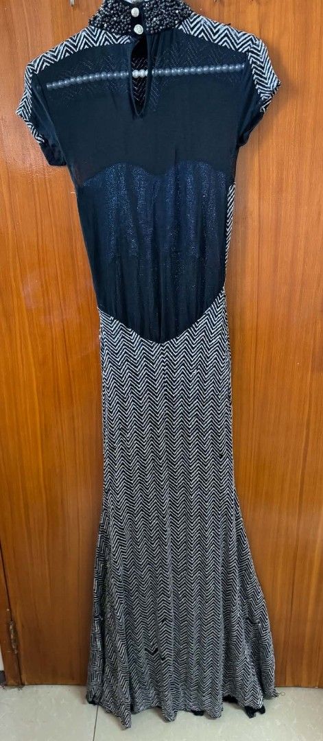 Black and Silver Chevron Maxi Dress Mock Neck (Category: Dresses) located in Caloocan City. Submitted by mylove326 (Listing ID 1469237656, Image 3). Description: - Design: Black and silver metallic chevron pattern with a - Details: Sheer black upper chest and back panels, beaded mock neck collar, and cute pearl button closure at the back - Sleeves: Short cap sleeves - Fabric: Heavy, premium fabric with comfortable stretch - Perfect for: Formal ev