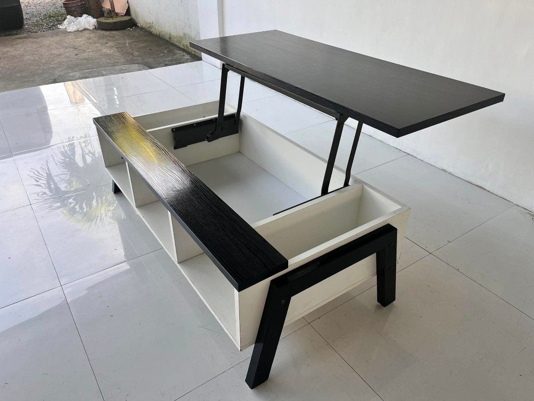 Black and White Lift-Top Coffee Table with Storage (Category: Tables & Sets) located in Manila. Submitted by roveeeeelen_06 (Listing ID 1469222783, Image 1). Description: - Multi-functional coffee table with a sleek black and white design - Pop-up top mechanism with sturdy metal hinges for comfortable working or dining - Hidden inner compartment underneath the lifting section for clutter-free living - Additional open side compartments and bottom 