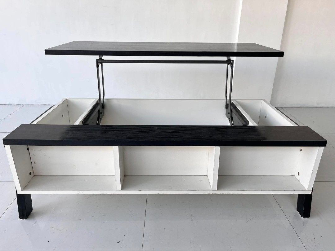 Black and White Lift-Top Coffee Table with Storage (Category: Tables & Sets) located in Manila. Submitted by roveeeeelen_06 (Listing ID 1469222783, Image 3). Description: - Multi-functional coffee table with a sleek black and white design - Pop-up top mechanism with sturdy metal hinges for comfortable working or dining - Hidden inner compartment underneath the lifting section for clutter-free living - Additional open side compartments and bottom 