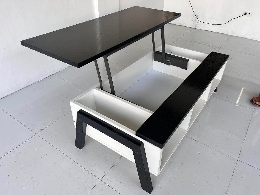 Black and White Lift-Top Coffee Table with Storage (Category: Tables & Sets) located in Manila. Submitted by roveeeeelen_06 (Listing ID 1469222783, Image 2). Description: - Multi-functional coffee table with a sleek black and white design - Pop-up top mechanism with sturdy metal hinges for comfortable working or dining - Hidden inner compartment underneath the lifting section for clutter-free living - Additional open side compartments and bottom 