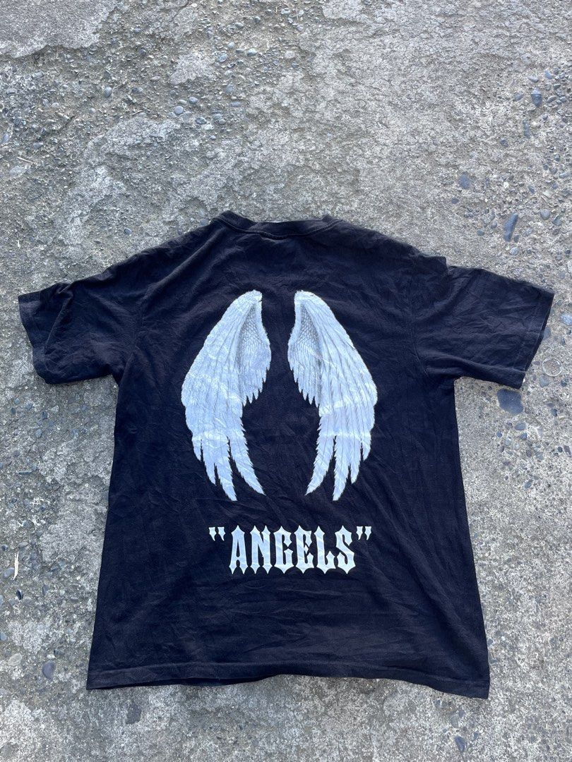 Black Angels Graphic T-Shirt (Category: Tshirts & Polo Shirts ) located in Manila. Submitted by coybns (Listing ID 1469187524, Image 2). Description: - Color: Black - Material: Heavy cotton - Fit: Standard fit with crew neck - Design: White gothic lettering on front; large white angel wings and matching gothic lettering on back - Style: Bold streetwear.