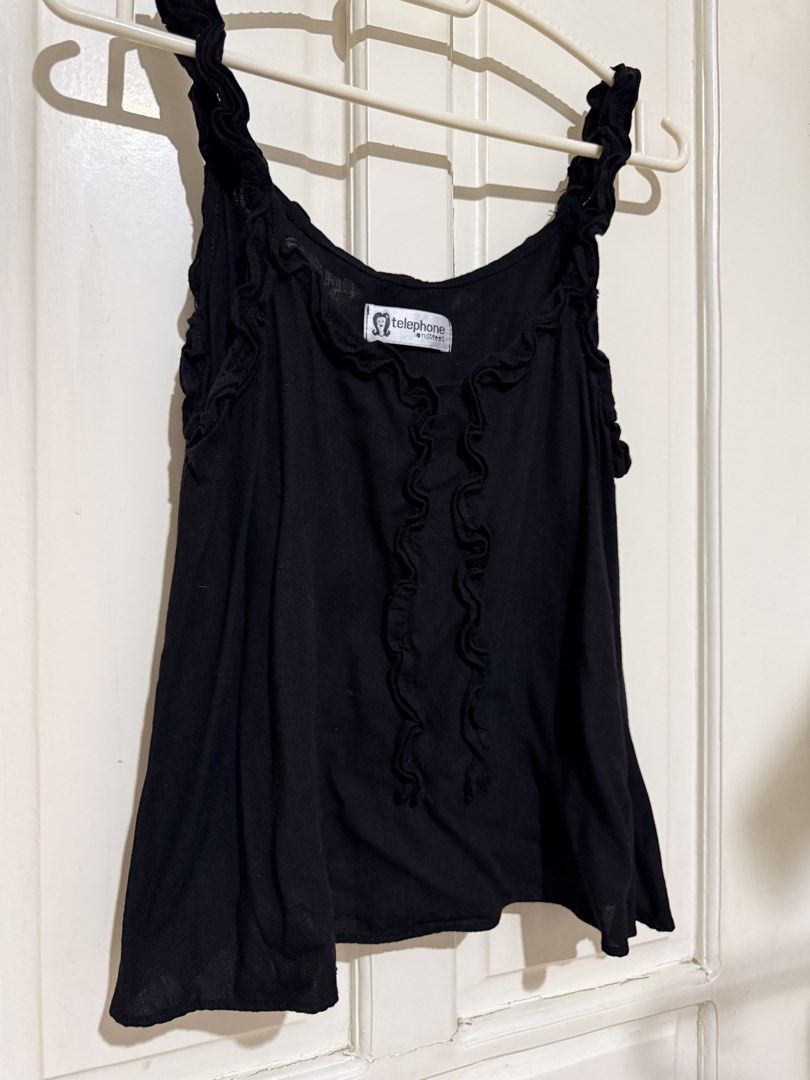 Black Cami Top (Category: Sleeveless) located in Marikina City. Submitted by louvy.r (Listing ID 1469378455, Image 1). Description: - Brand: Telephone Onstreet - Color: Black - Design: Cute ruffled straps, vertical ruffles on the front, and scoop neckline - Fabric: Lightweight and comfortable - Styling: Great basic piece for layering or wearing alone with jeans and skirts.
