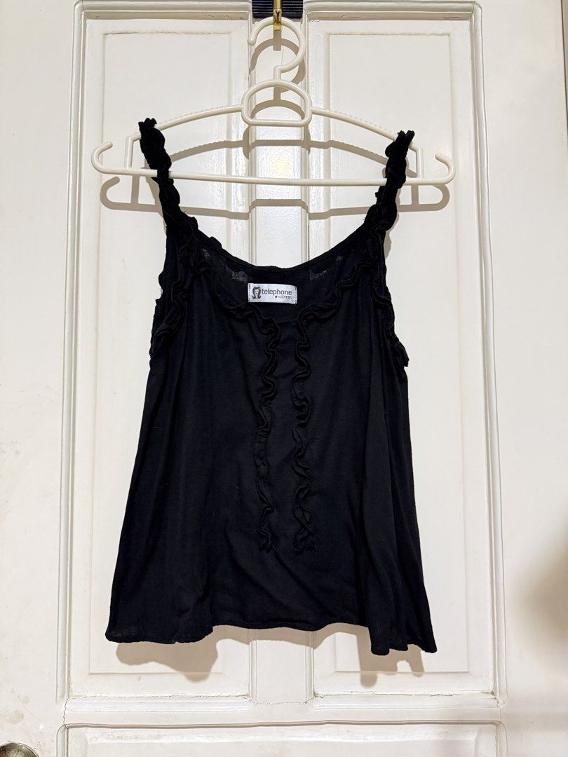 Black Cami Top (Category: Sleeveless) located in Marikina City. Submitted by louvy.r (Listing ID 1469378455, Image 3). Description: - Brand: Telephone Onstreet - Color: Black - Design: Cute ruffled straps, vertical ruffles on the front, and scoop neckline - Fabric: Lightweight and comfortable - Styling: Great basic piece for layering or wearing alone with jeans and skirts.