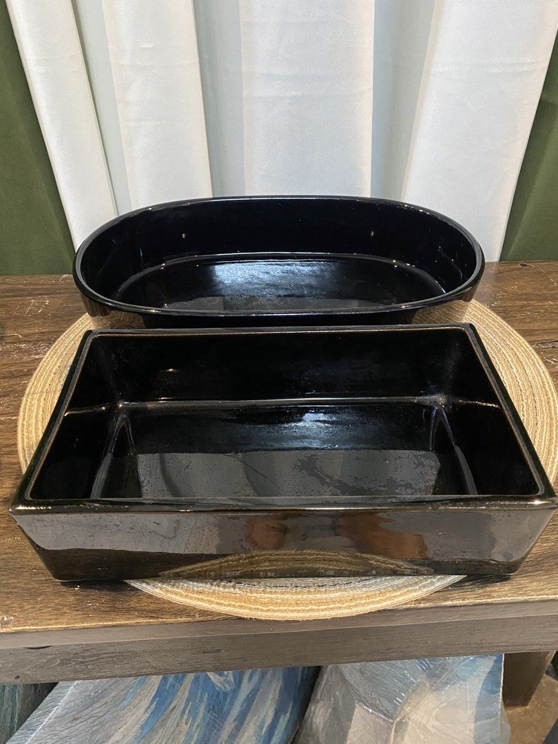 Black Ceramic Oval and Rectangular Serving Dish Set (Category: Dinnerware & Cutlery) located in San Pedro. Submitted by jingay81 (Listing ID 1469380091, Image 1). Description: - Set of matching black ceramic serving dishes (oval and rectangular shapes) - Elegant glossy finish with a stylish gold leaf accent square - Crafted from heavy, high-quality stoneware material - Clean interiors with normal surface wear from regular use - Versatile pieces i