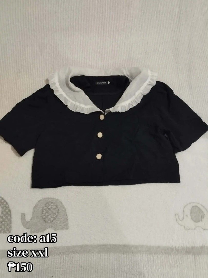 Black Crop Top with White Ruffle Collar Code a15 (Category: Sleeveless) located in Carmona. Submitted by ichorvault (Listing ID 1469285878, Image 1). Description: - Color: Black with contrasting white ruffled collar - Style: Short-sleeve crop top with front button closure - Material: Soft and comfortable fabric - Fit: Tag size XXL (great for pairing with high-waisted skirts or pants) - Item Code: a15.