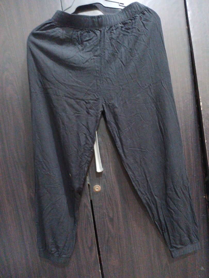 Black joggers with drawstring waist and elastic cuffs (Category: Joggers) located in Manila. Submitted by ggarage.sale (Listing ID 1469208724, Image 3). Description: - Color: Black - Style: Casual joggers with a relaxed fit - Material: Lightweight, comfortable fabric for all-day wear - Waistband: Elastic with a white adjustable drawstring - Ankles: Cuffed for a secure fit - Best for: Lounging at home or running errands.