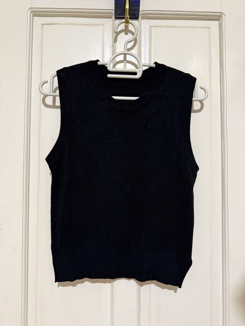Black Knit Sleeveless Sweater Vest (Category: Sleeveless) located in Marikina City. Submitted by louvy.r (Listing ID 1469378111, Image 1). Description: - Color: Black - Style: Sleeveless knit sweater vest with classic crew neckline - Material: Soft and comfortable cotton blend - Fit: Standard, versatile fit for easy styling - Features: Ribbed hem and arm openings - Best for: Layering over button-downs or wearing in cooler weather.